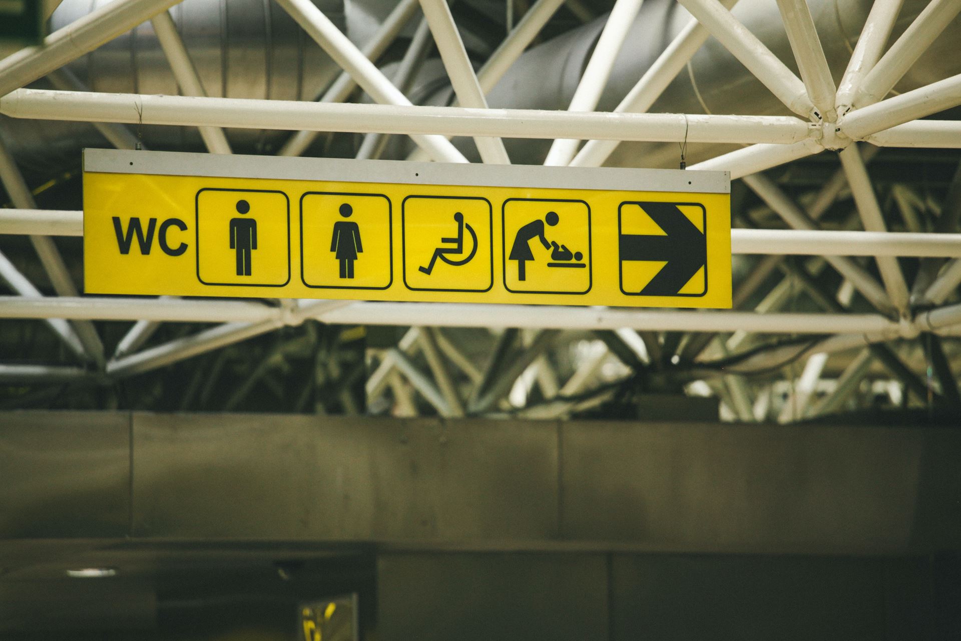 image of toilet sign, wheelchair, baby changing and arrow